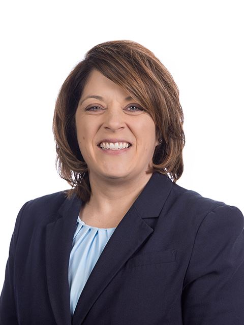 Portrait of a Commissioner Bigham in a dark suit and light blue shirt, on a white background.